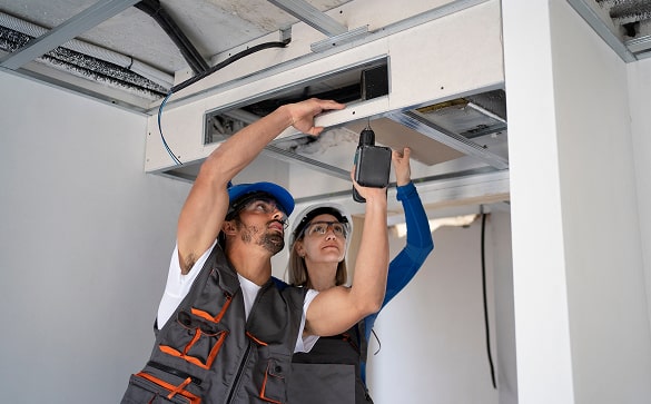 HVAC technician inspecting and servicing commercial boiler