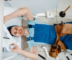 HVAC technician with a drill and a happy family relaxing at home.