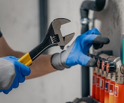 Technician repairing broken pipe in residential home