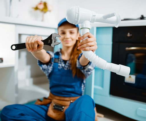 Female HVAC technician with a drill and a happy family relaxing at home.